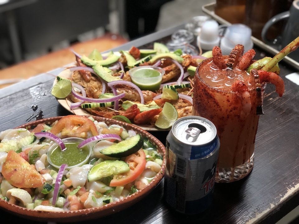 Colorful plates of ceviche and shrimp.