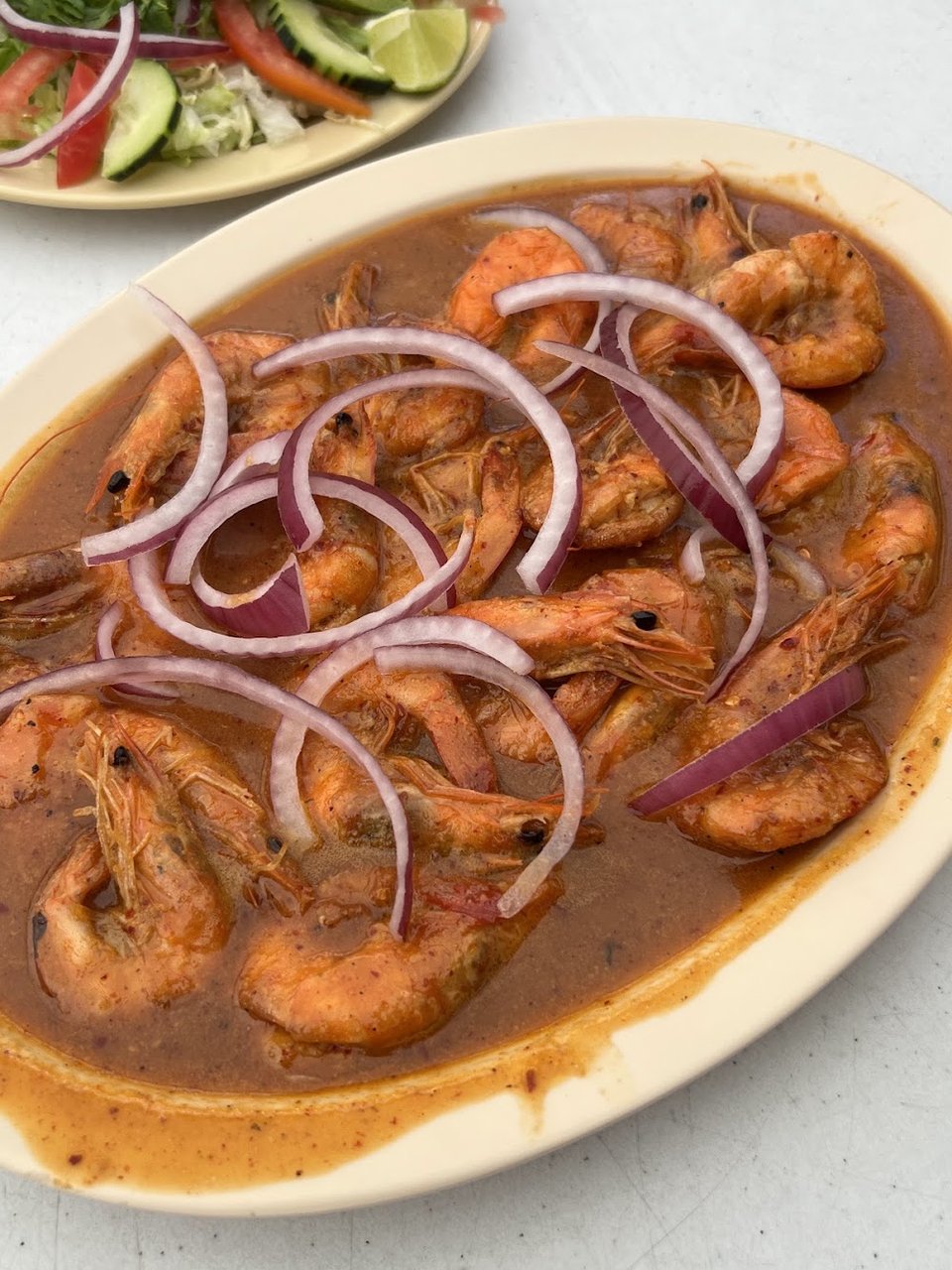 Shrimp dish served with fresh garnishes.