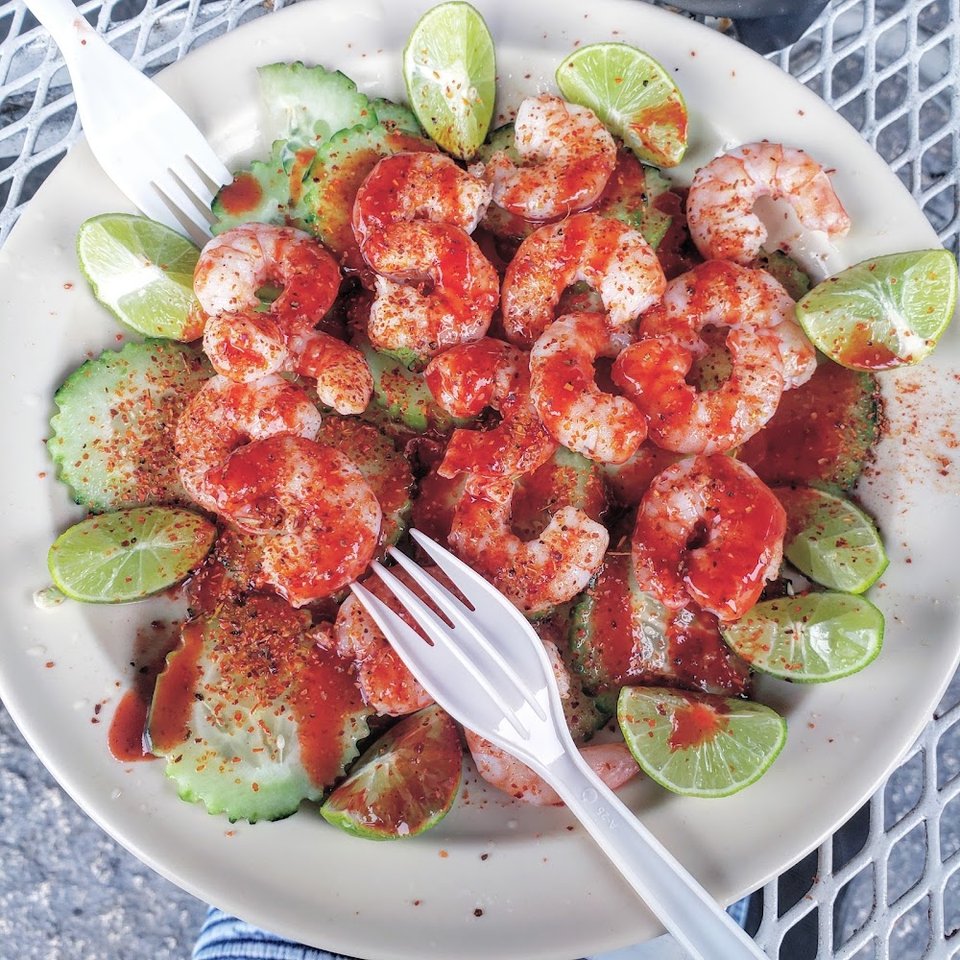Shrimp dish served with fresh garnishes.